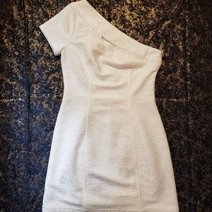 White one shoulder dress.